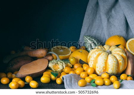 Pumpkins, Kumquats, Orange, Sweet Potato, Carrot, Autumn Composition on Dark Wooden Background, Toned Picture, Free Space for Text