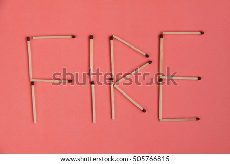 Matches stick set up in word "FIRE" on pink background