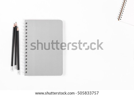 Top view brown and white notebook, notepad paper and pencil pen on white background.