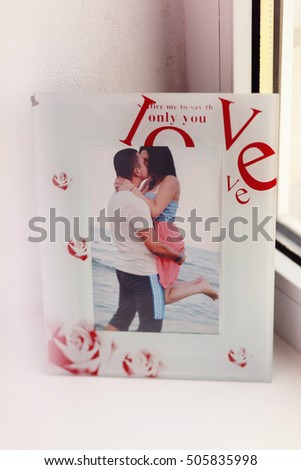 Picture of kissing couple put in the white frame