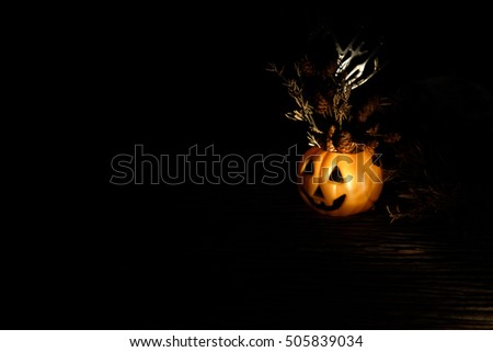 Dark halloween orange Pumpkin with dried flowers. Low key tone.