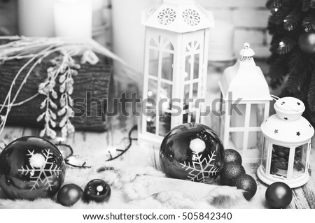 Black and white photo of New Year Holiday Celebration Christmas decorations with balls lantern on fir tree background, white candles decor, Xmas, Studio, Stock, Creative concept, Design, Objects