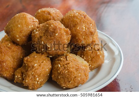 Dessert of Thailand, tasty desserts of Southern Thailand. (Artocarpus integer, Fritter) On a white plate, on a wooden table.