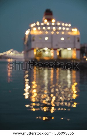 Boat blurred reflections over the sea - Dusk skyline bokeh over the sea - Pier at night