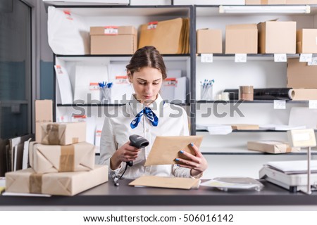 young woman working at the post office Royalty-Free Stock Photo #506016142
