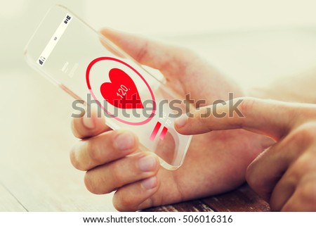 medicine, healthcare, technology and people concept - close up of male hand holding and showing transparent smartphone
