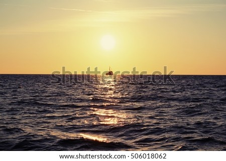 Sunset over sea, ship on the horizont