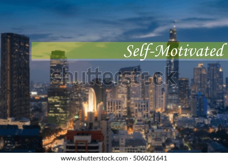 Hand writing SELF-MOTIVATED  with the abstract bokeh on background. This word represent the business as concept in stock photo.