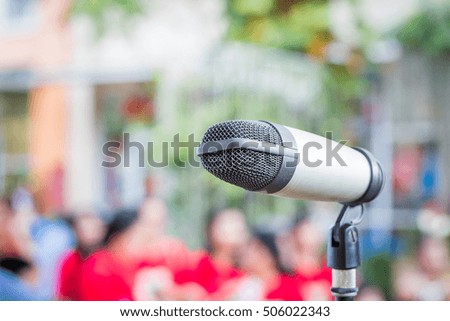Close up of microphone in public place with blur background