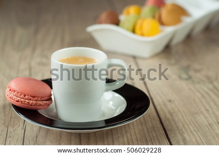 Colorful macrons over turquoise wooden backround