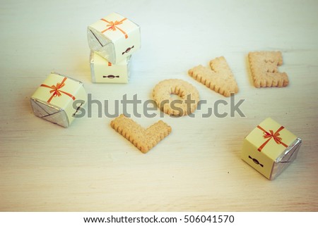 Love concept, romantic background with bisquit made letters. Cookies alphabet, wedding and date design, love message. Toned image.