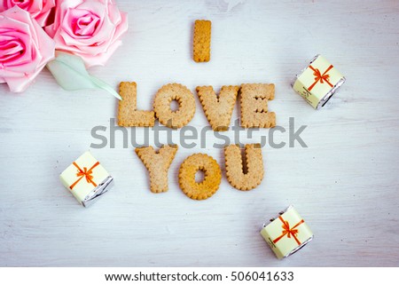 I love you, romantic background with bisquit made letters. Cookies alphabet, wedding and date design, love message. Toned image.