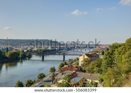 Prague cityscape in an afternoon sun with Vltava river flowing through the city center, Czech republic. Photo taken at Vysehrad.