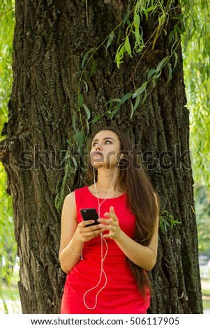 Young woman listening music on the street