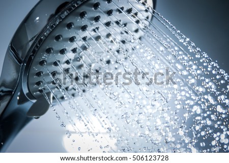 Image of a modern shower head splashing water close up background. Royalty-Free Stock Photo #506123728