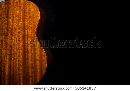 Acoustic instrument Close-up  some ukulele on a black background Space for text template  music