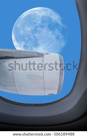 Full moon on blue sky in window airplane  "Elements of this image furnished by NASA