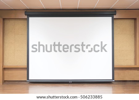 Front view of lecture room with empty white projector screen Royalty-Free Stock Photo #506233885