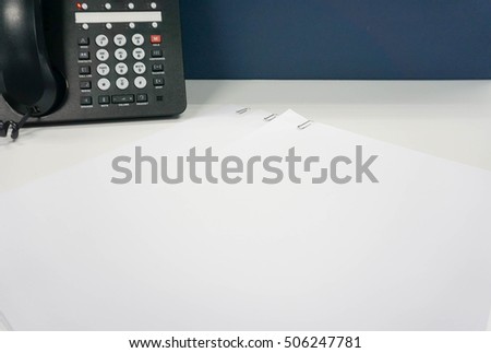 mock up white paper sheet with paper clip in IP phone backdrop