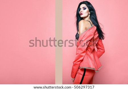 Amazing Surprised Teenage Gil holding her red jacket,woman costume,amazing glam make-up showing idea gesture. Joyful Excited Clever young woman ready for party, isolated on red background