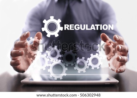 Businessman is using tablet pc and selecting regulation