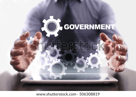 Businessman is using tablet pc and selecting government