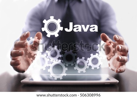 Businessman is using tablet pc and selecting java