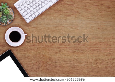 Office table with notepad, phone, computer and coffee cup. View from above with copy space