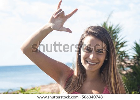 young woman doing rock gesture