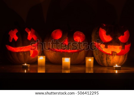 Halloween pumpkins with scary face and burning candle 