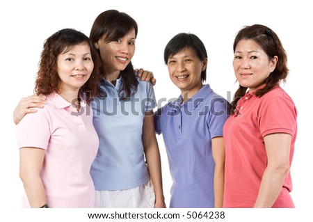 A group of Asian women standing together in the studio talking
