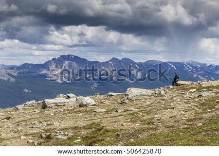 Woman looking out over a valley in the Rocky Mountains - Jasper National Park, Alberta, Canada