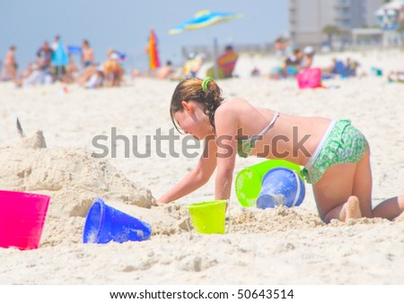 Young girl building sand castle