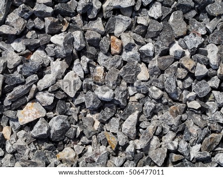 texture surface of grey blue color sharp edges small mountain stone raw materials for concrete cement mixing, outdoor under natural sunlight