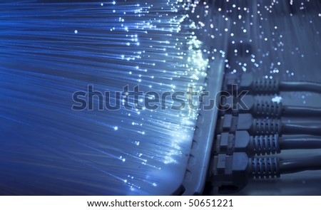 network cable and hub closeup with fiber optical background Royalty-Free Stock Photo #50651221