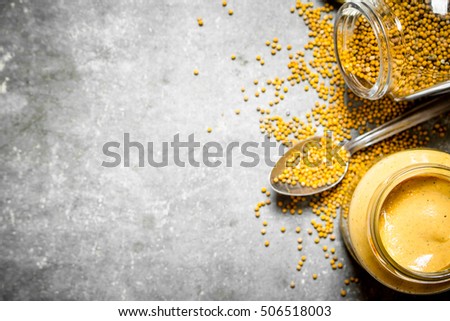 Fresh mustard with seed. On the stone table.
