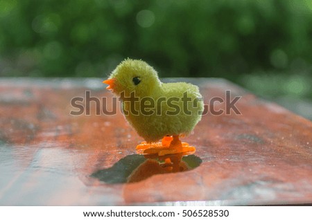 Chick dolls, toys for children, on a table made of wood and background bokeh tree. (Select focus)