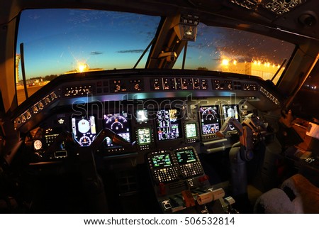 Cockpit of modern civil airplane at night. Royalty-Free Stock Photo #506532814