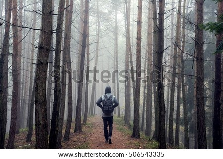 Man in foggy autumn forest
