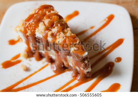 Banoffee pie with caramel sauce on the woden table