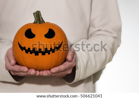 Treats pumpkin in hands / Halloween Background 