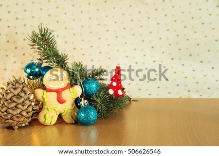 gingerbread man near Christmas tree with toys by garland, the concept of Christmas