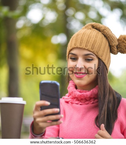 Technology internet and happiness concept. Woman happy girl taking self picture selfie with smartphone camera outdoors in autumn park on bench