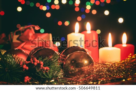 Red and white candles on a dark background