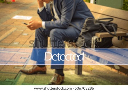 Hand writing detected with the abstract background. The word detected  represent the action in business as concept in stock photo.