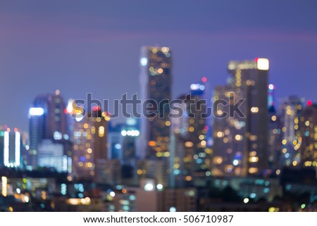Twilight blurred bokeh lights, office building downtown, abstract background