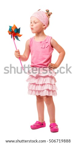 Cute little blond girl blowing windmill isolated on white background.