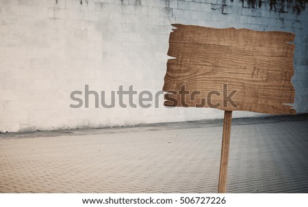 Weathered cinder block, brick wall texture, wood sign and walkway