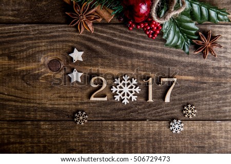 Sigh symbol from number 2017 on vintage style wooden texture background. Happy New Year 2017 greetings on wooden. snowflake wood. Empty space for your text. instead of zero snowflake Royalty-Free Stock Photo #506729473