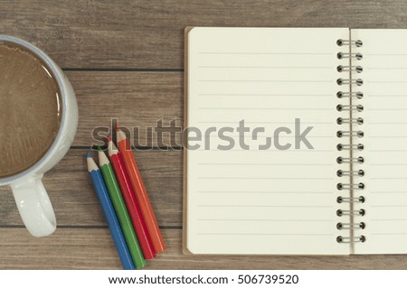 Pencils, note book and a cup of coffee on the wooden table. business conceptual.